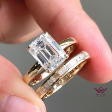 Load image into Gallery viewer, Medium Emerald Cut Hidden Halo Basket Tension Band D Color Two-Piece Moissanite Bridal Set