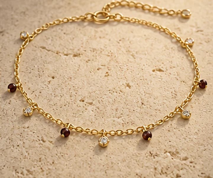 Illustrative delicate gold and gemstone anklet