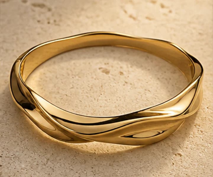 Illustrative substantial sculptural gold bangle
