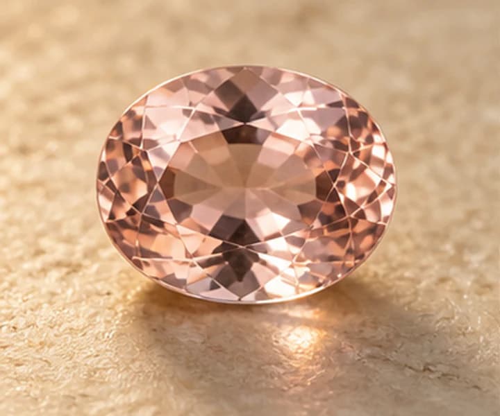 Illustrative morganite jewelry direction on warm ivory stone