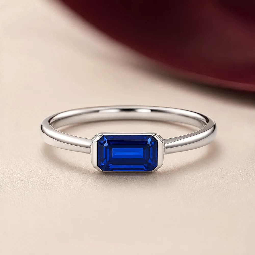 A blue-toned fine-jewelry ring direction in a refined setting.