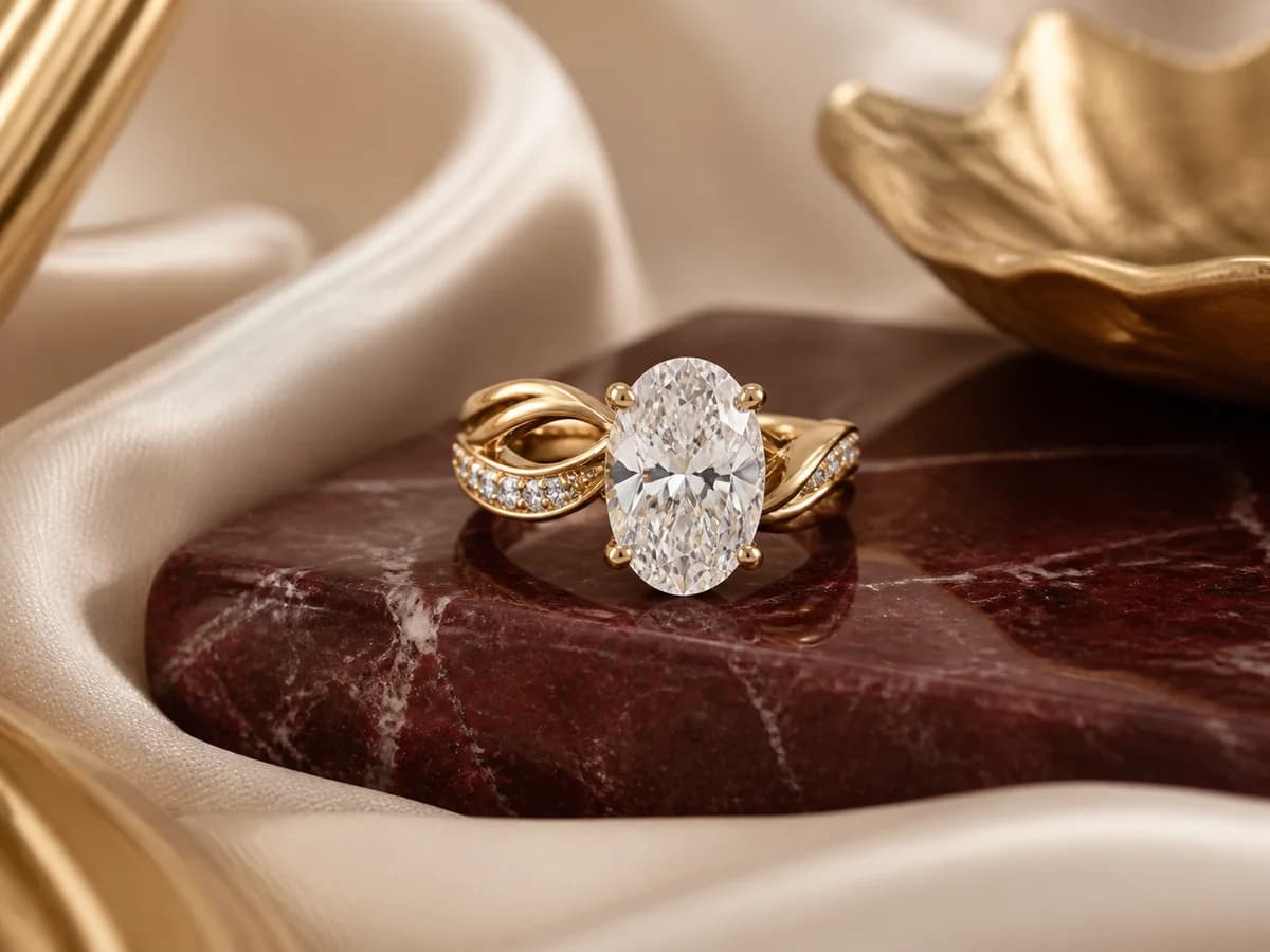 Illustrative three-carat oval engagement-ring direction in a refined jewelry still life